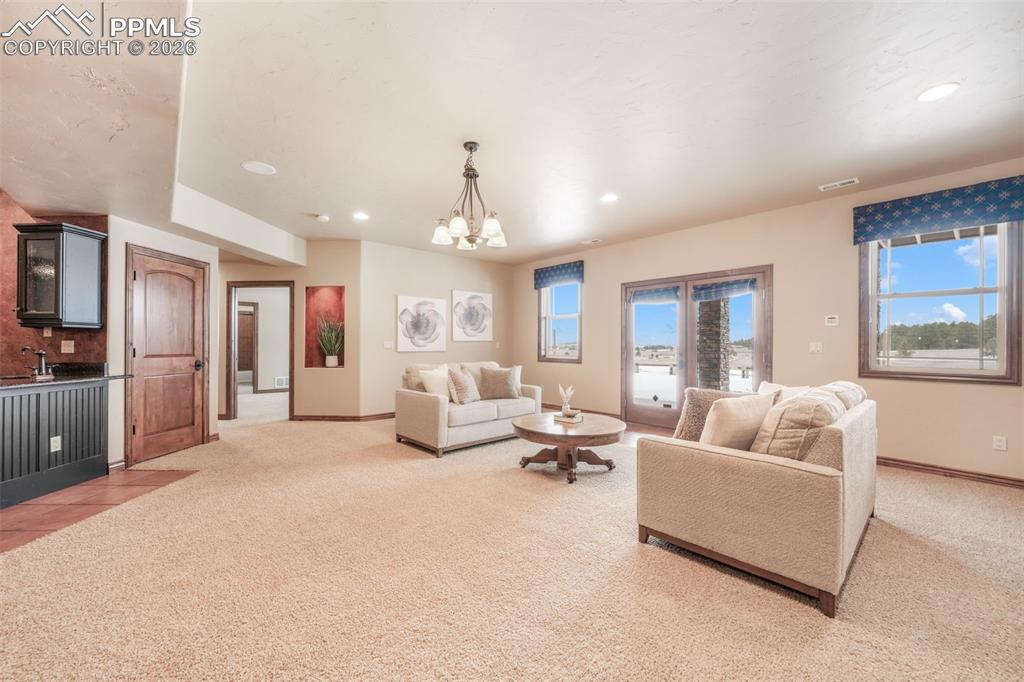 7830 Tannenbaum Road Colorado Springs, CO 80908 - Photo 36 of 50 a living room with furniture and a large window