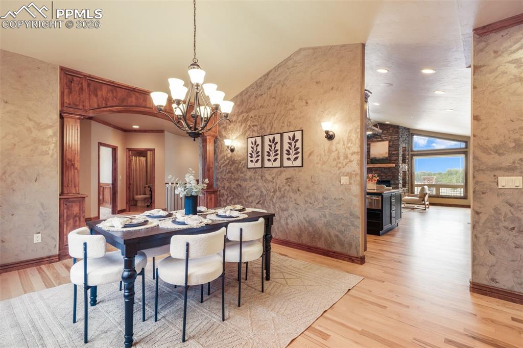7830 Tannenbaum Road Colorado Springs, CO 80908 - Photo 5 of 50 a view of a dining room with furniture and wooden floor