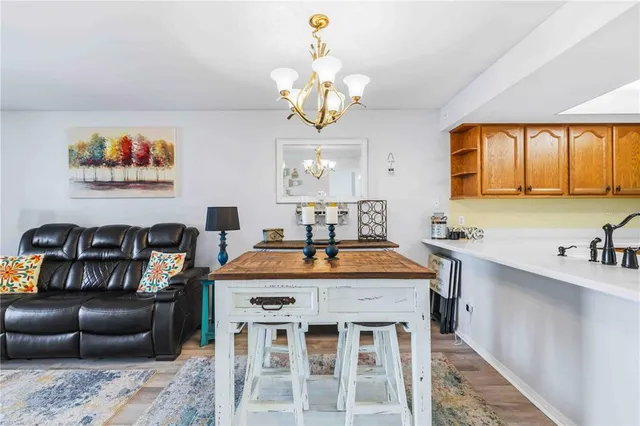 a kitchen with stainless steel appliances granite countertop a refrigerator a stove and a sink with cabinets