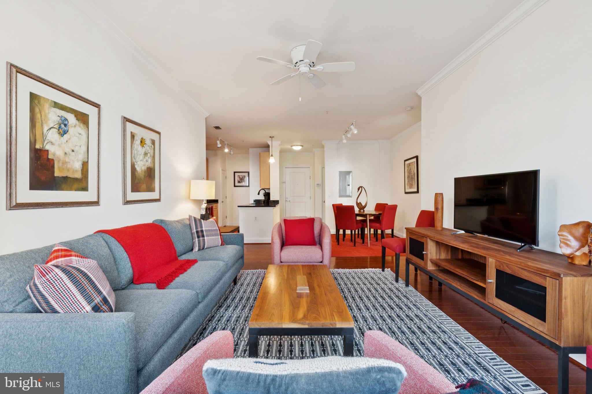 1391 Pennsylvania Ave. Southeast, Unit 352 Washington, DC 20003 - Photo 13 of 43 a living room with furniture and a flat screen tv