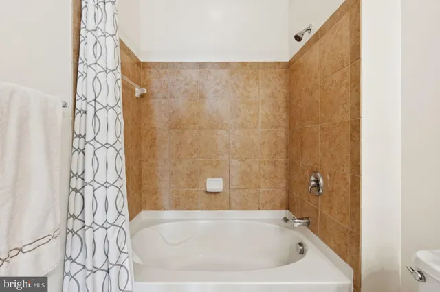 a bathroom with a bathtub and shower