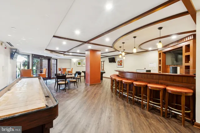 a dining room with furniture and wooden floor