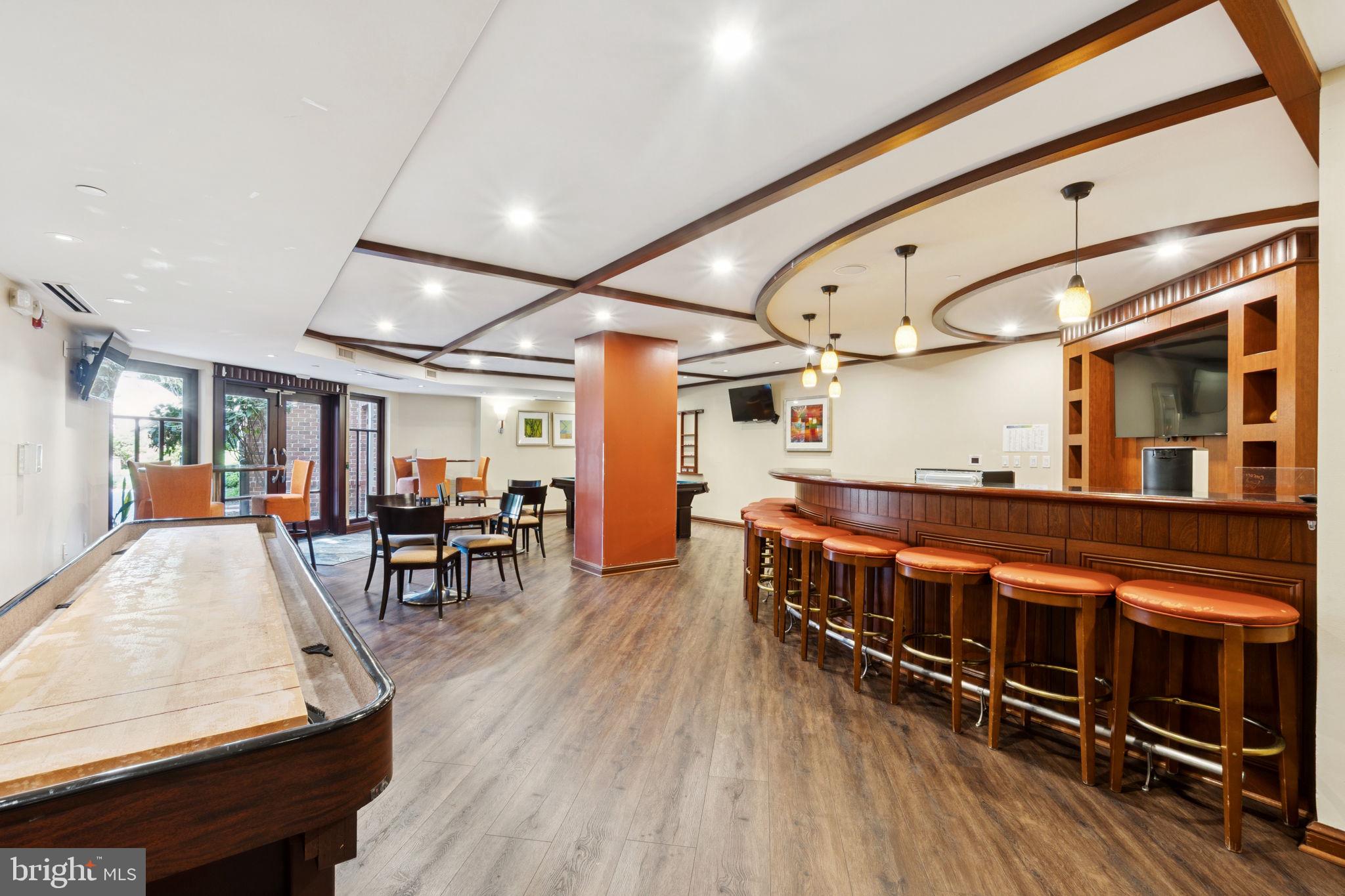 1391 Pennsylvania Ave. Southeast, Unit 352 Washington, DC 20003 - Photo 33 of 43 a large room with wooden furniture and a large window