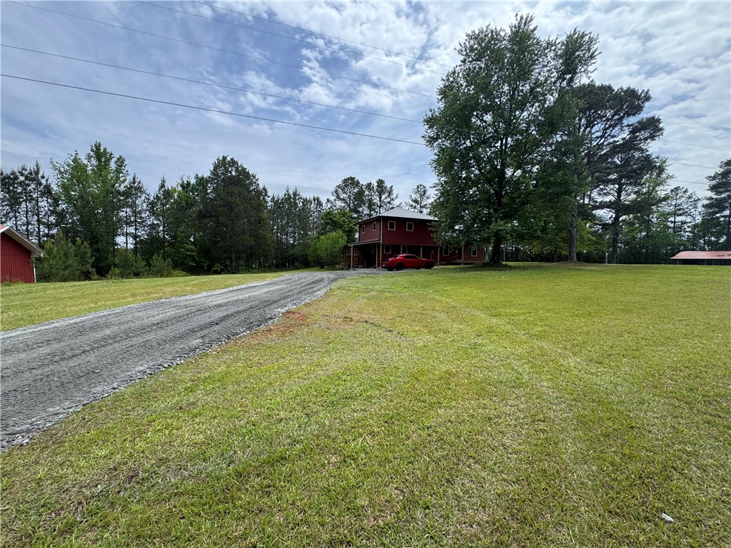 17419 Highway 76 W Honea Path Honea Path, SC 29654 - Photo 50 of 50 This spacious property features a charming home nestled among lush greenery, offering a serene escape.