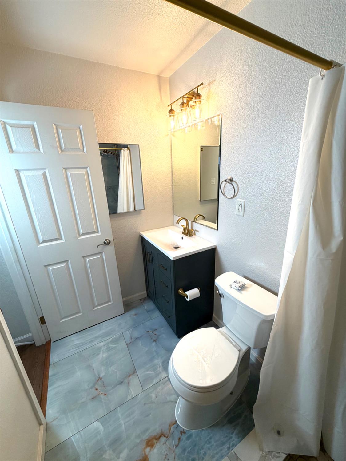5000 Bremner Way, Unit 4 Sacramento, CA 95841 - Photo 11 of 23 a bathroom with a sink toilet and shower