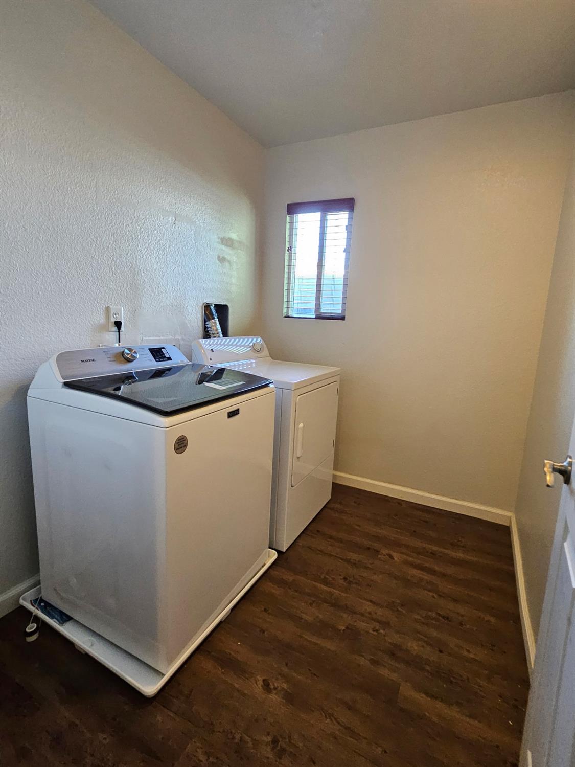 5000 Bremner Way, Unit 4 Sacramento, CA 95841 - Photo 12 of 23 a room with a sink a mirror and wooden floor