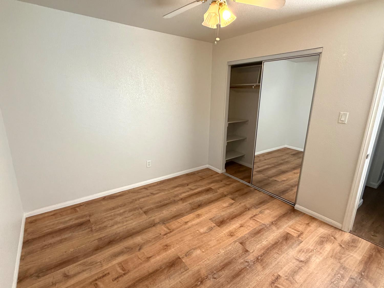5000 Bremner Way, Unit 4 Sacramento, CA 95841 - Photo 15 of 23 a view of a room with wooden floor and bedroom