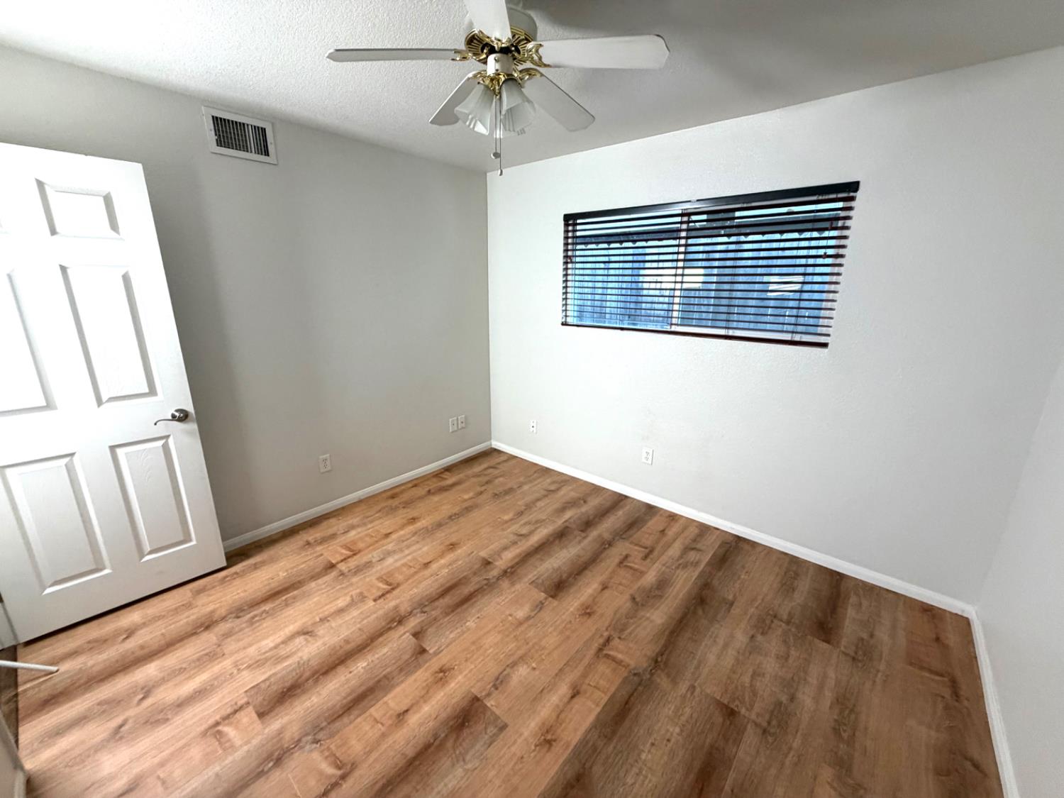 5000 Bremner Way, Unit 4 Sacramento, CA 95841 - Photo 16 of 23 a view of an empty room with wooden floor and a window