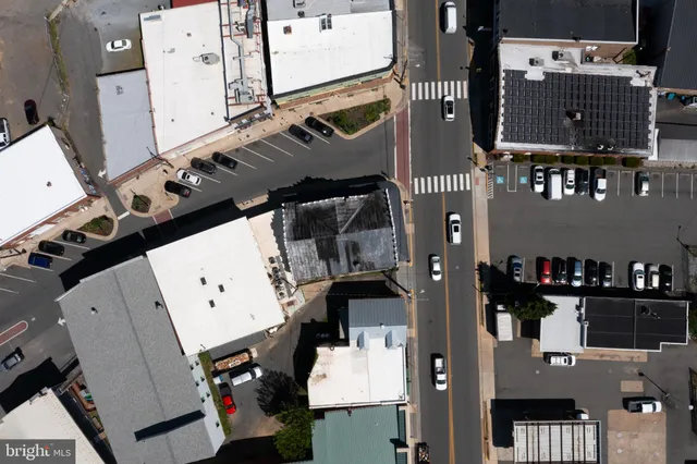 an aerial view of residential house with parking