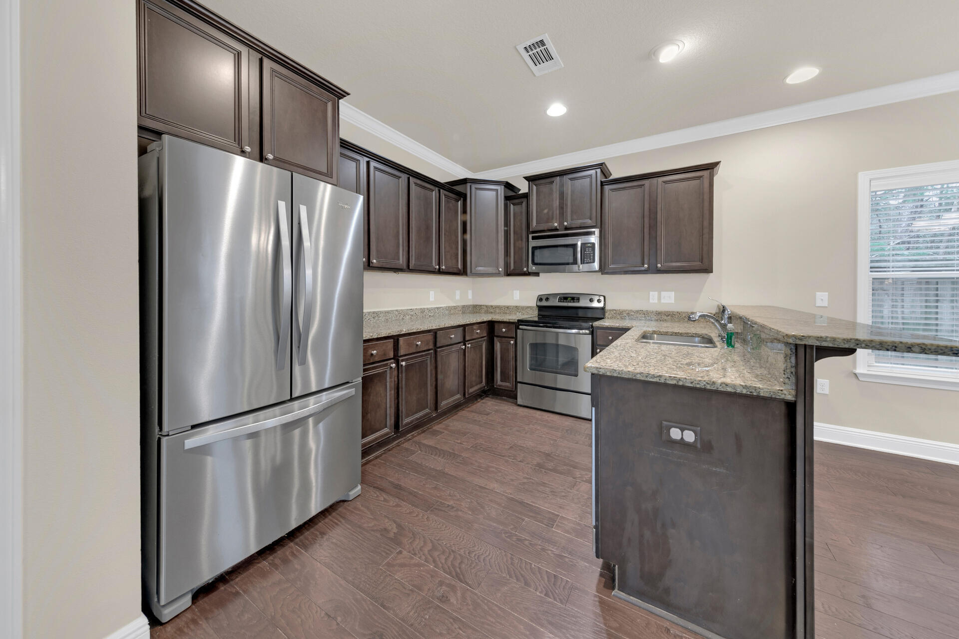 40 Horn Beam Way Santa Rosa Beach, FL 32459 - Photo 12 of 37 a kitchen with stainless steel appliances granite countertop a refrigerator a stove a sink and a microwave