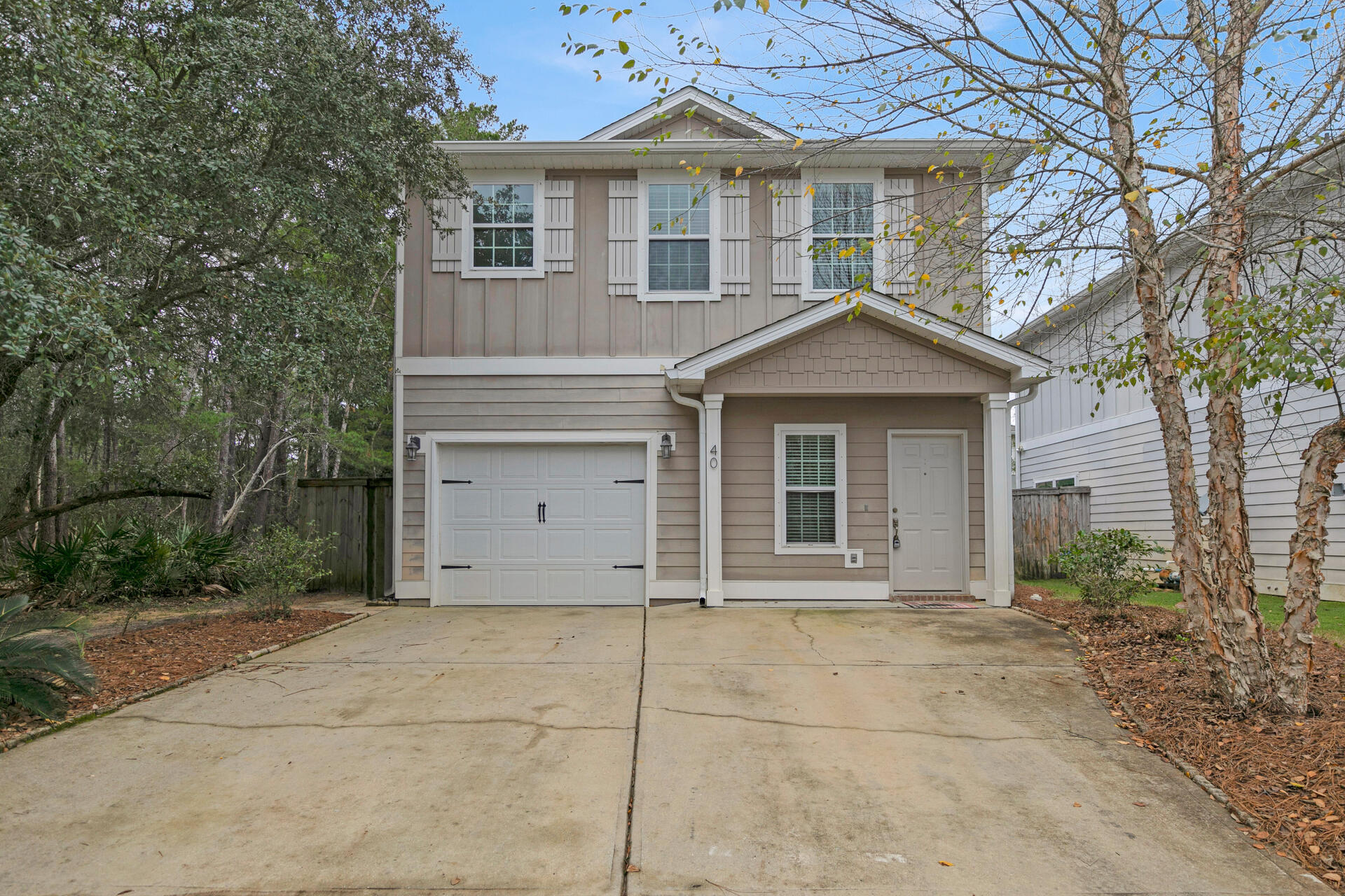 40 Horn Beam Way Santa Rosa Beach, FL 32459 - Photo 2 of 37 a front view of a house with a garden