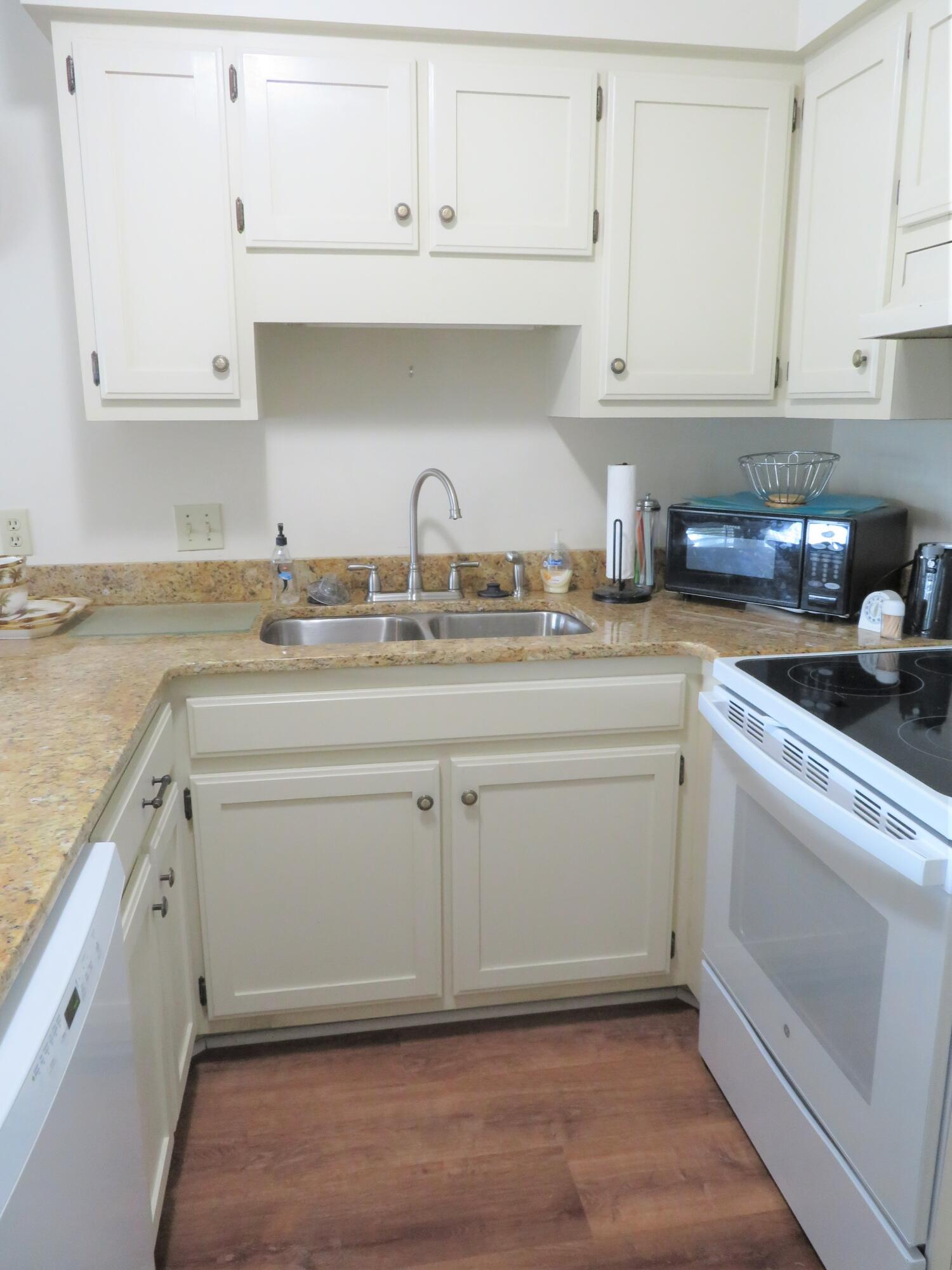 17670 Front Beach Road, Unit B4 Panama City Beach, FL 32413 - Photo 5 of 14 a kitchen with white cabinets appliances and a sink