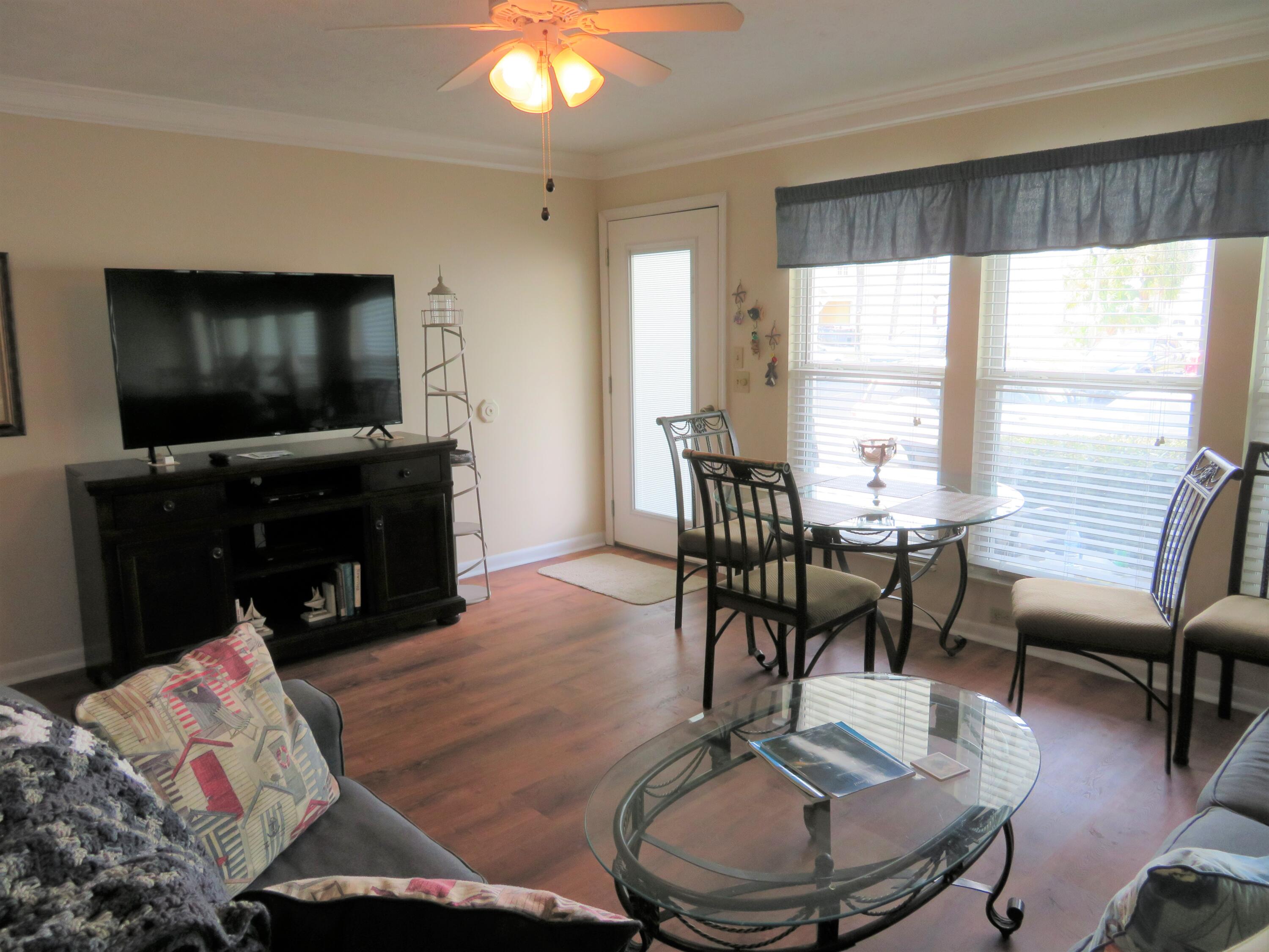 17670 Front Beach Road, Unit B4 Panama City Beach, FL 32413 - Photo 6 of 14 a living room with furniture and a flat screen tv