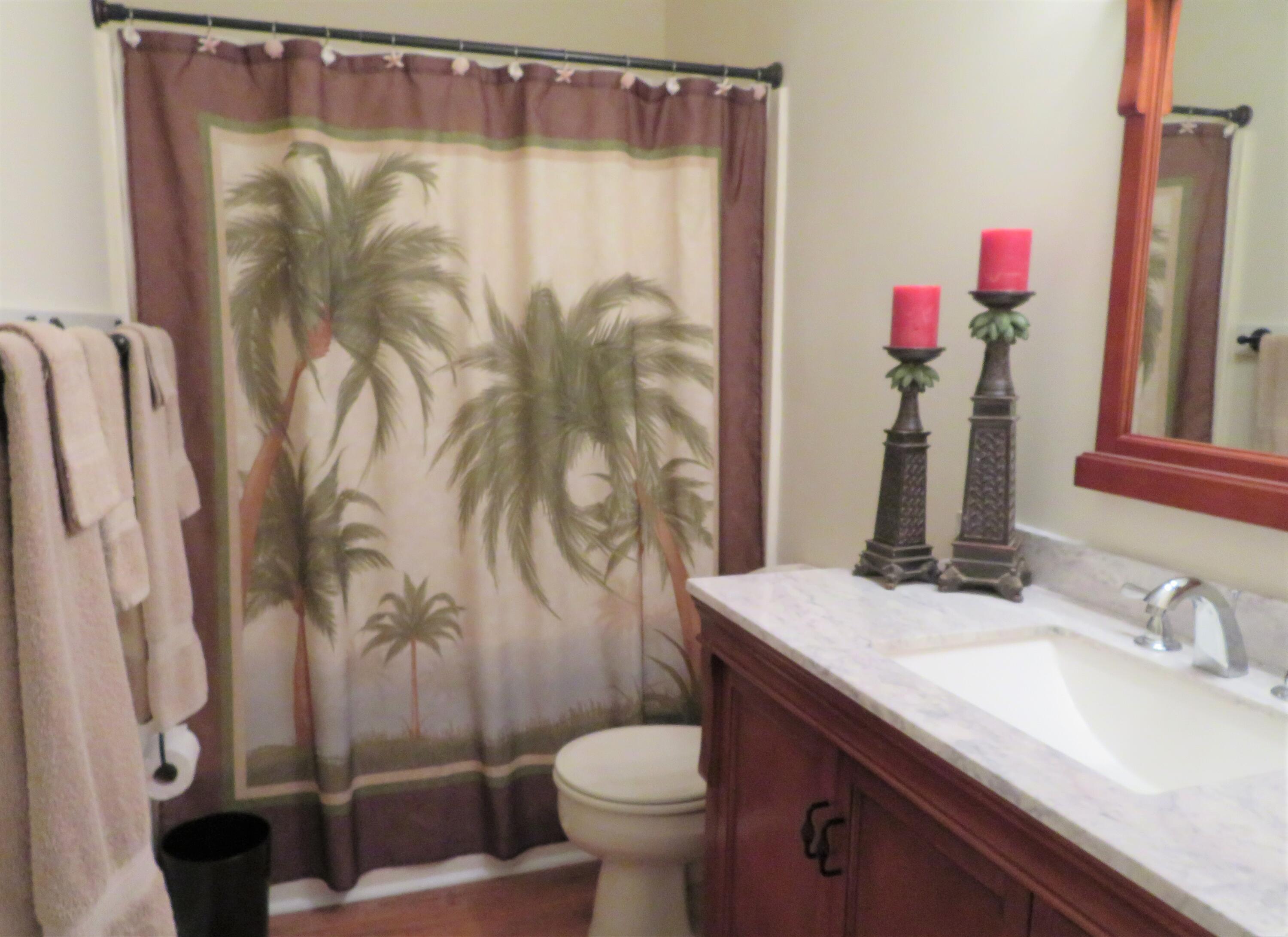 17670 Front Beach Road, Unit B4 Panama City Beach, FL 32413 - Photo 8 of 14 a bathroom with a sink vanity mirror and toilet