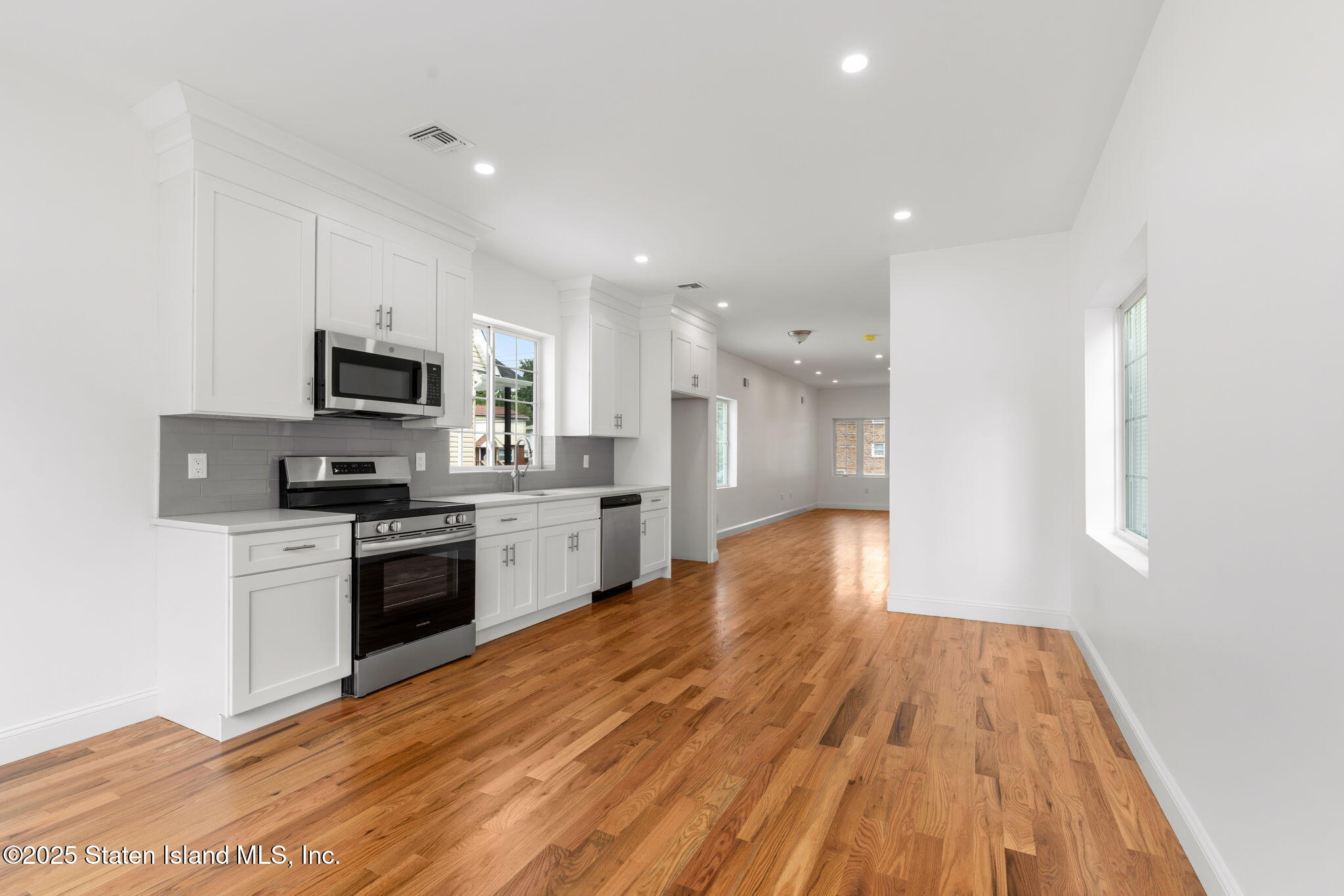 1384 Clove Road Staten Island, NY 10301 - Photo 11 of 51 a kitchen with a sink stainless steel appliances and cabinets