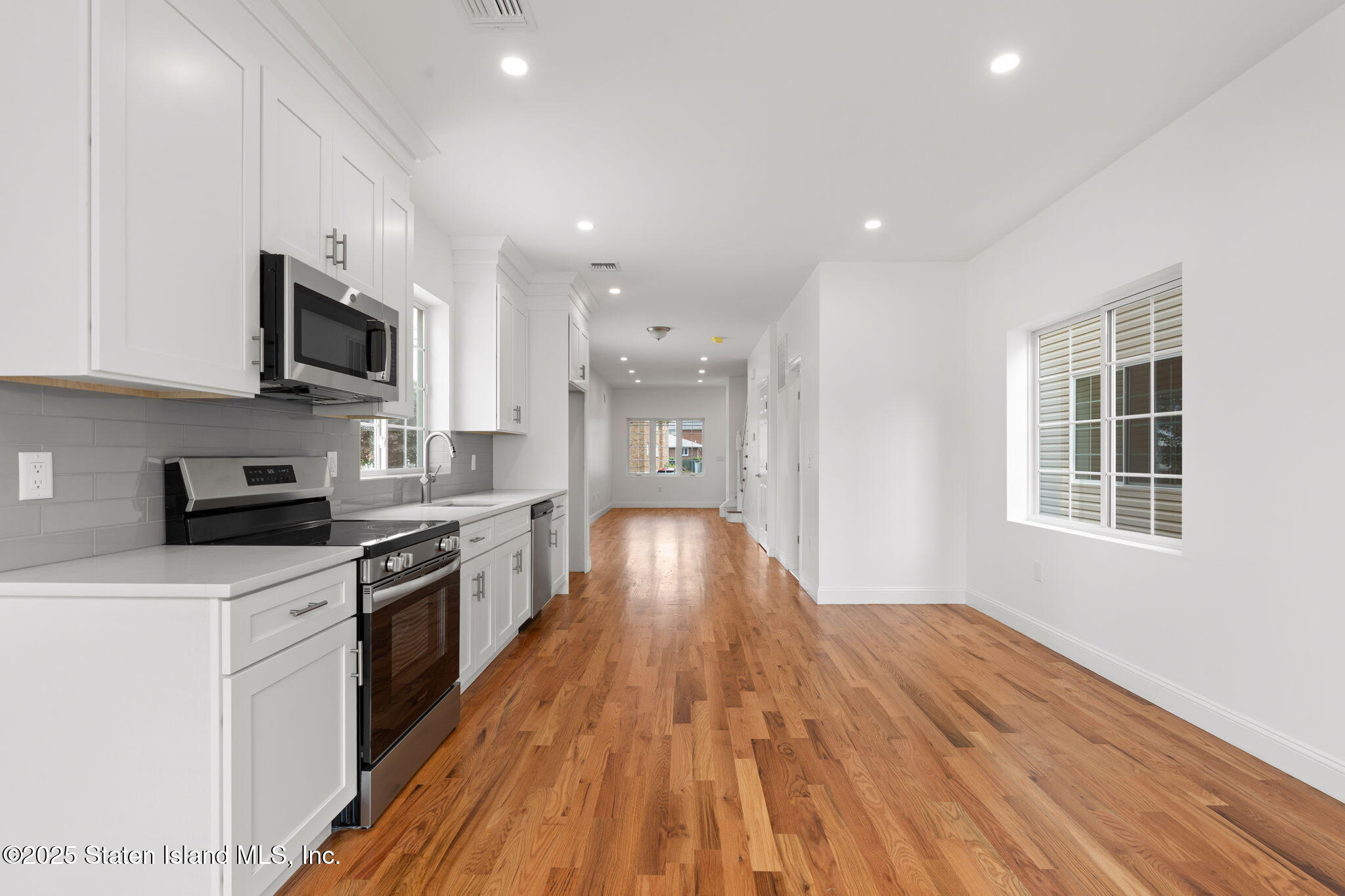 1384 Clove Road Staten Island, NY 10301 - Photo 12 of 51 a large kitchen with stainless steel appliances granite countertop a stove and a sink