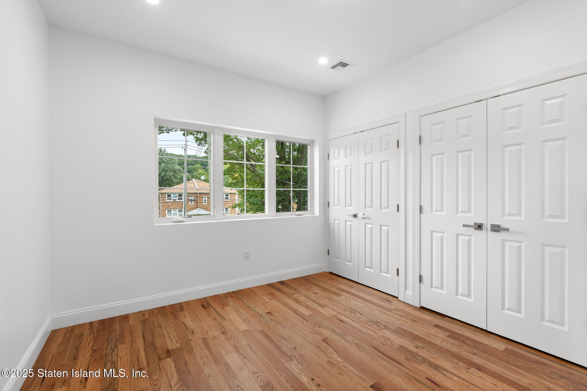 1384 Clove Road Staten Island, NY 10301 - Photo 18 of 51 wooden floor in an empty room