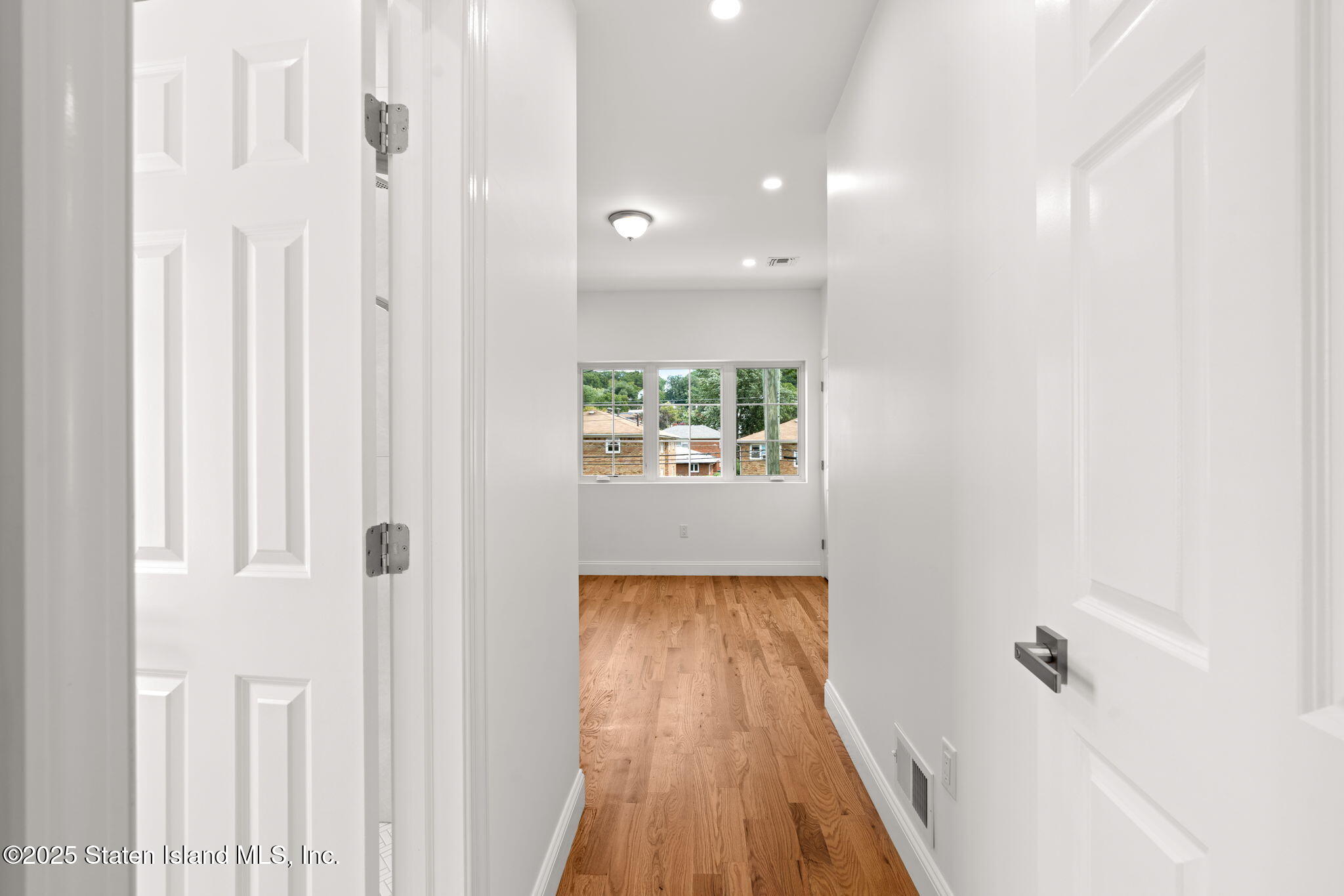 1384 Clove Road Staten Island, NY 10301 - Photo 19 of 51 a view of a hallway with wooden floor and staircase