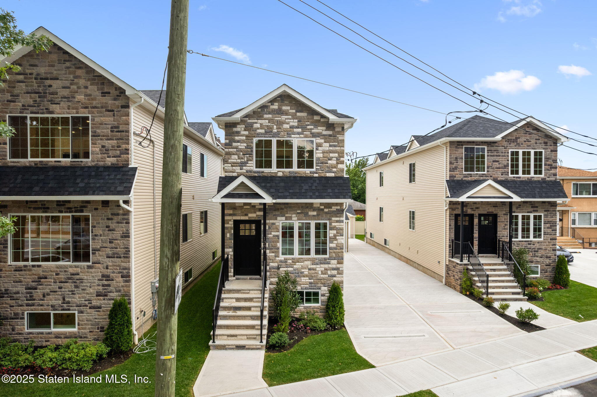 1384 Clove Road Staten Island, NY 10301 - Photo 2 of 51 a front view of a house with a garden