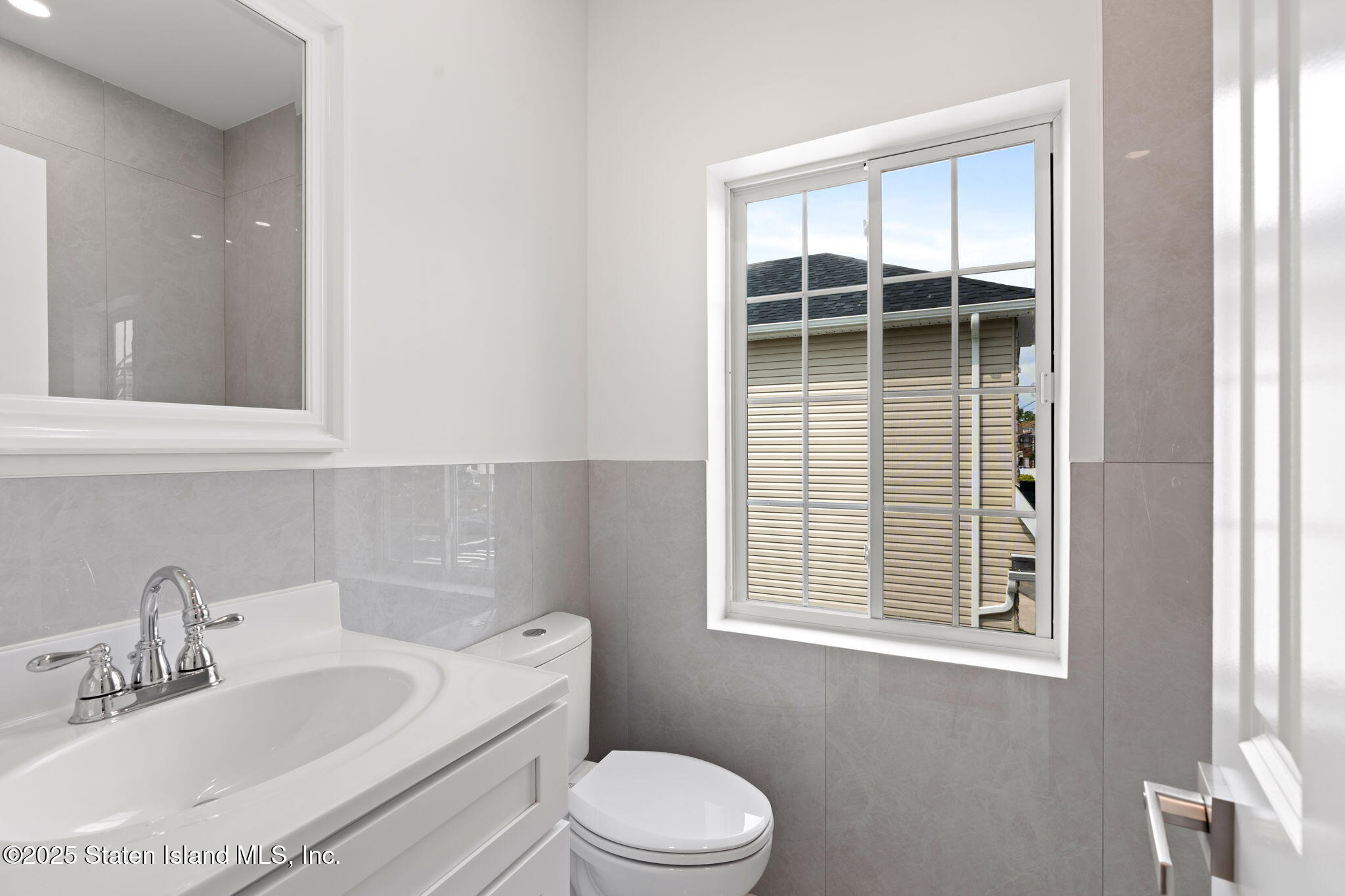 1384 Clove Road Staten Island, NY 10301 - Photo 22 of 51 a bathroom with a sink toilet and window