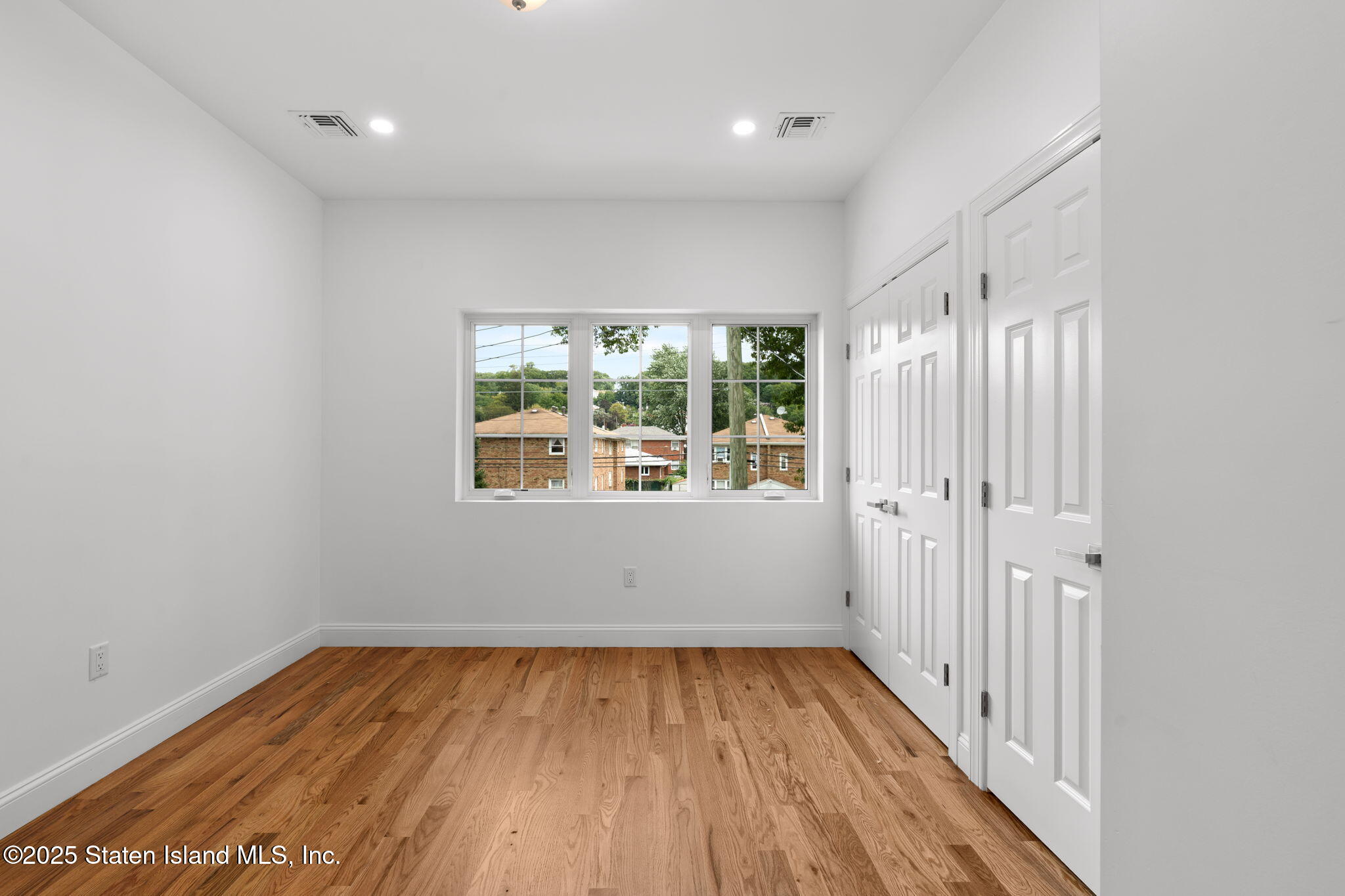 1384 Clove Road Staten Island, NY 10301 - Photo 23 of 51 wooden floor in an empty room