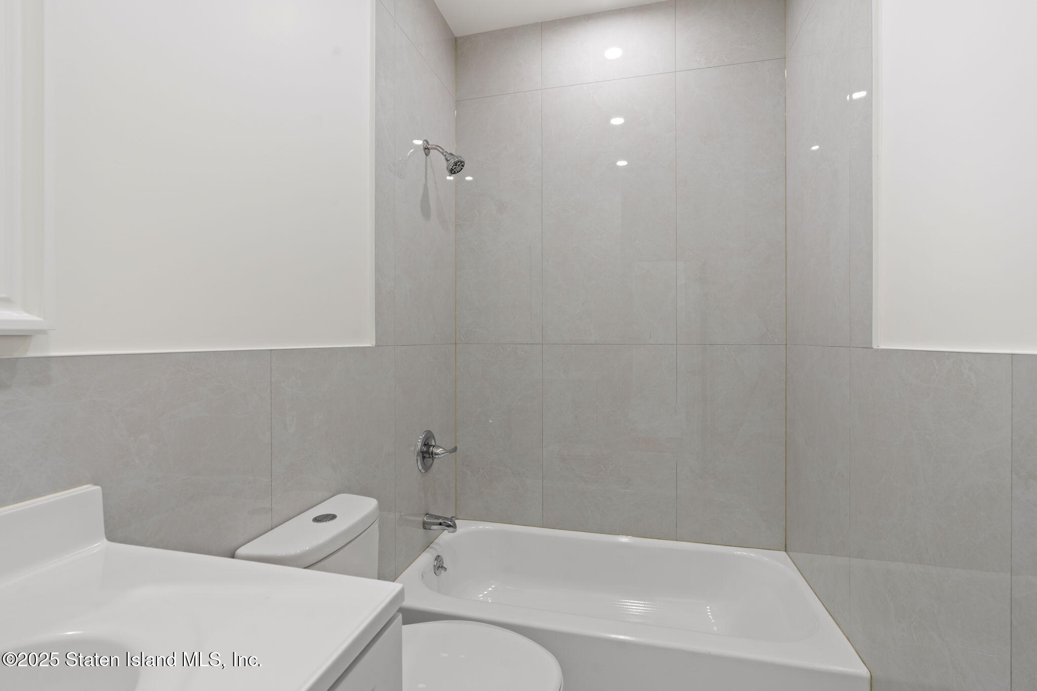 1384 Clove Road Staten Island, NY 10301 - Photo 30 of 51 a bathroom with a bathtub and shower