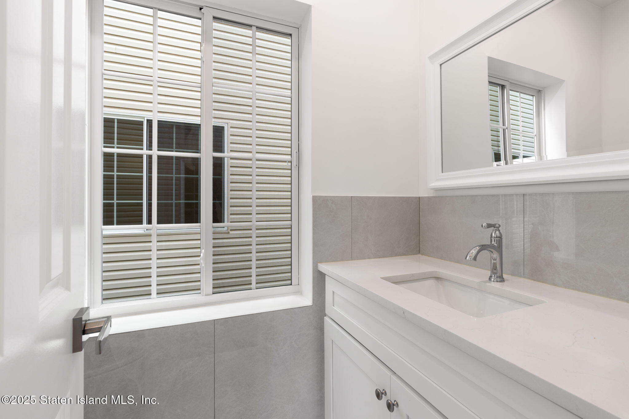 1384 Clove Road Staten Island, NY 10301 - Photo 34 of 51 a bathroom with a sink and a window