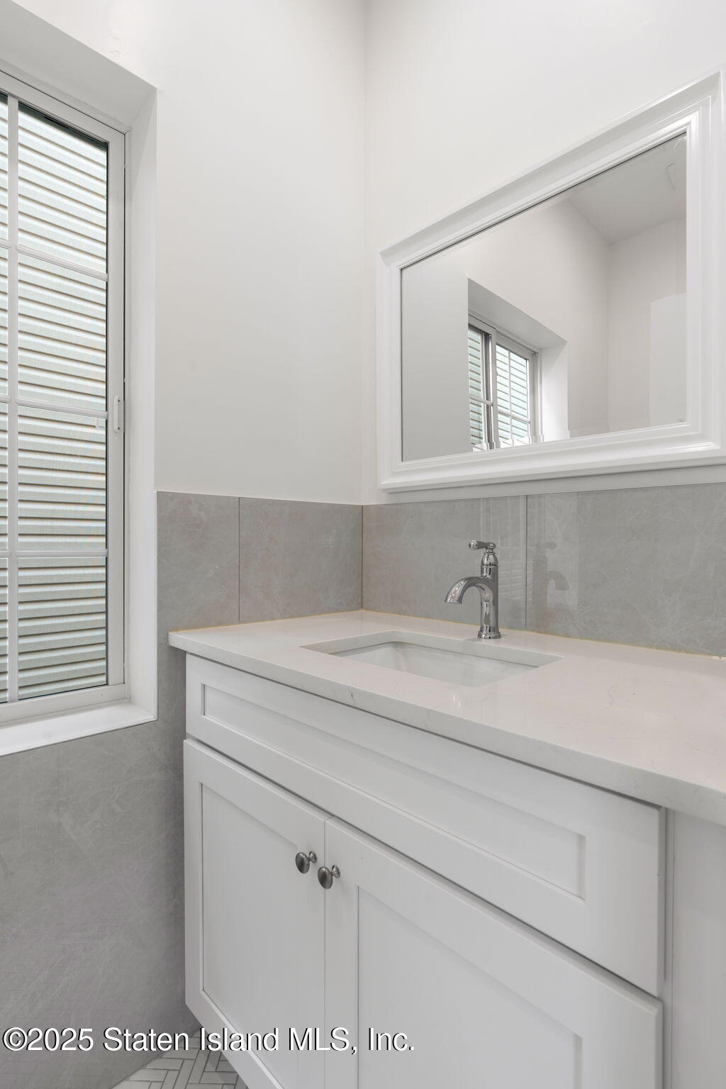 1384 Clove Road Staten Island, NY 10301 - Photo 35 of 51 a bathroom with a sink and a mirror