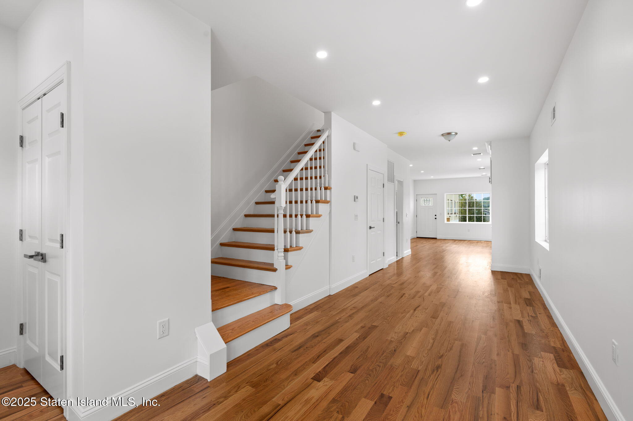 1384 Clove Road Staten Island, NY 10301 - Photo 5 of 51 a view of a hallway with wooden floor and staircase
