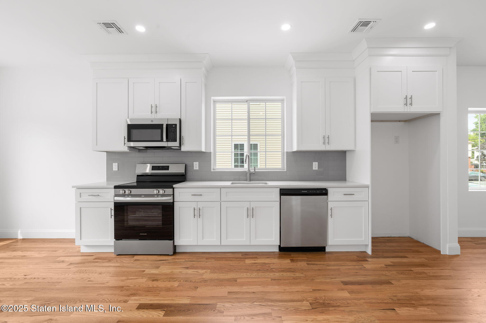 1384 Clove Road Staten Island, NY 10301 - Photo 10 of 51 a kitchen with stainless steel appliances granite countertop a stove a sink and a microwave
