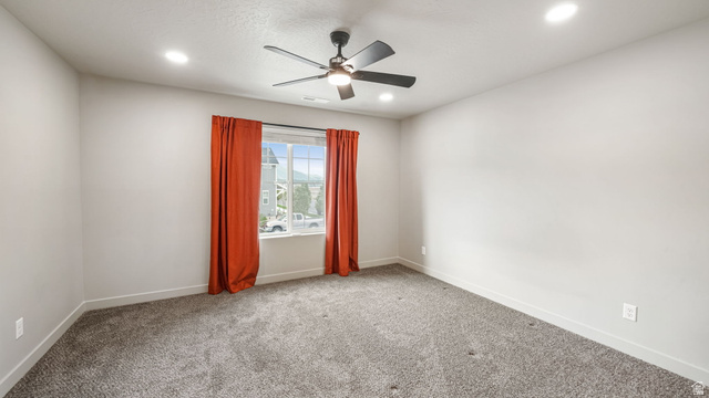 1223 East 1775 North Payson, UT 84651 - Photo 31 of 45 Spacious room featuring neutral carpeting, a multi-pane window, and a ceiling fan with integrated lighting