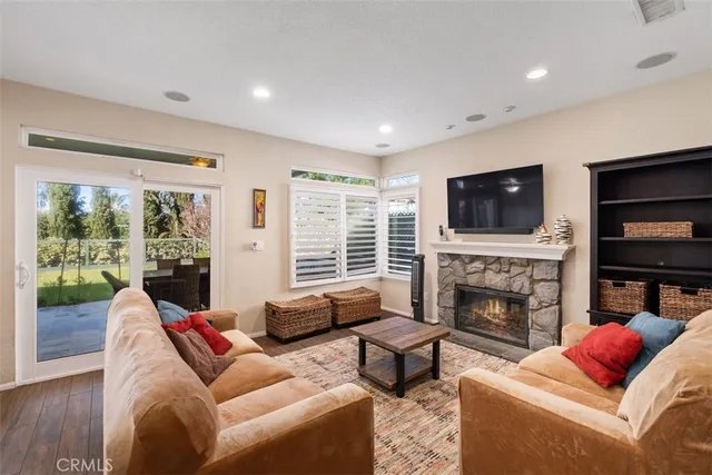 a living room with furniture fireplace and flat screen tv