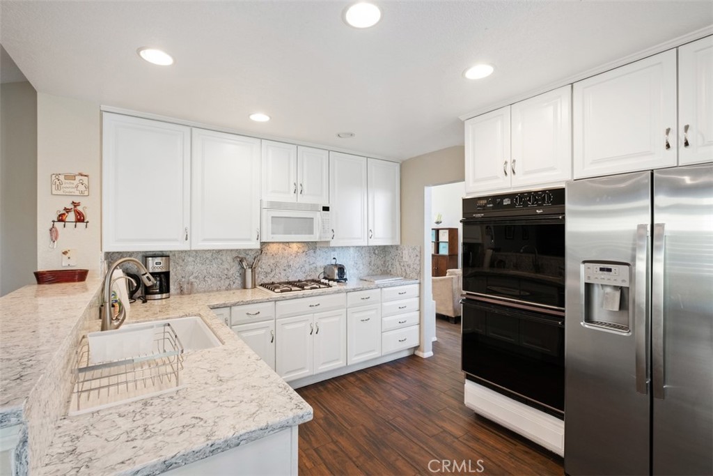 20891 Porter Ranch Road Rancho Santa Margarita, CA 92679 - Photo 12 of 40 a kitchen with a refrigerator sink and cabinets
