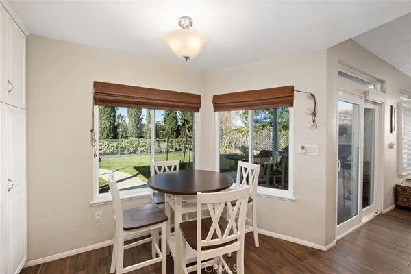 a view of a dining room with furniture wooden floor and chandelier