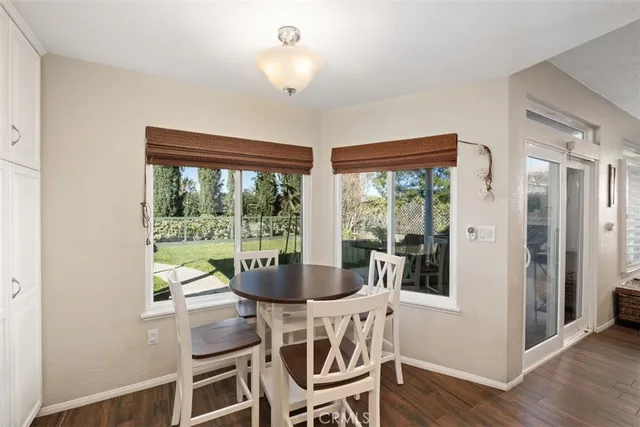 a view of a dining room with furniture wooden floor and chandelier