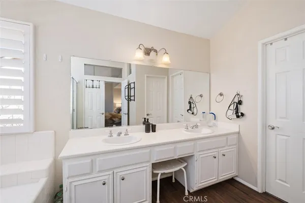 a bathroom with a sink vanity and a mirror