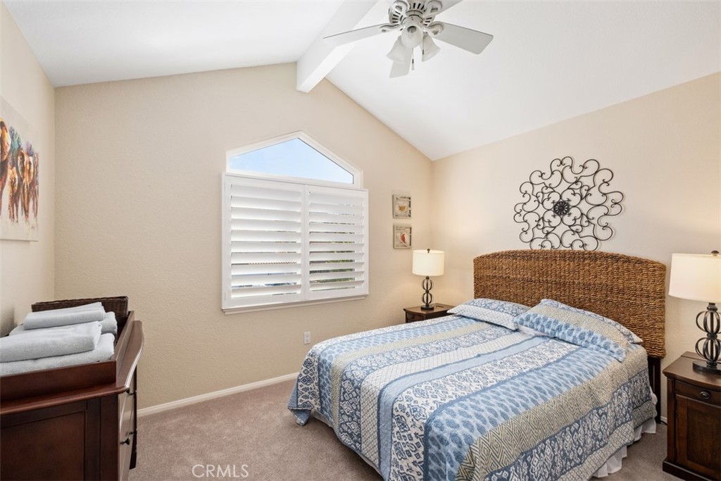 20891 Porter Ranch Road Rancho Santa Margarita, CA 92679 - Photo 26 of 40 a bedroom with a bed and a chandelier