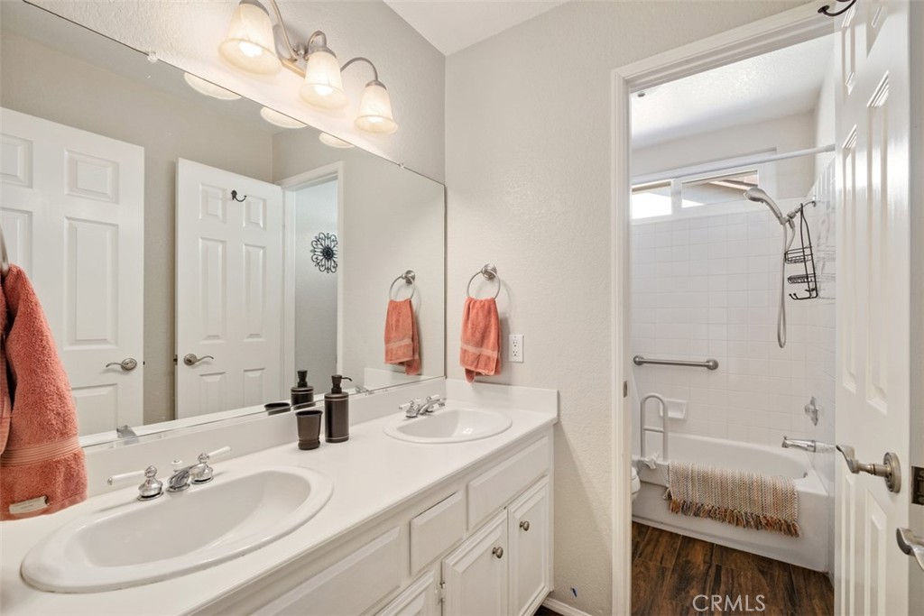20891 Porter Ranch Road Rancho Santa Margarita, CA 92679 - Photo 27 of 40 a bathroom with a sink vanity and a mirror