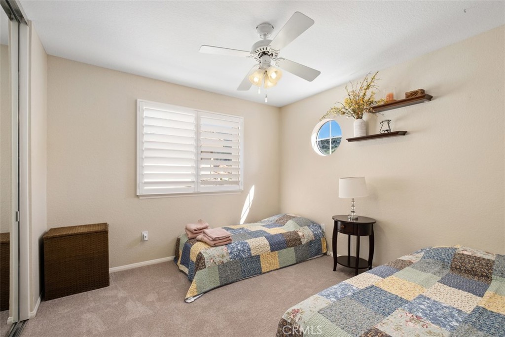20891 Porter Ranch Road Rancho Santa Margarita, CA 92679 - Photo 28 of 40 a bedroom with a bed and a chandelier