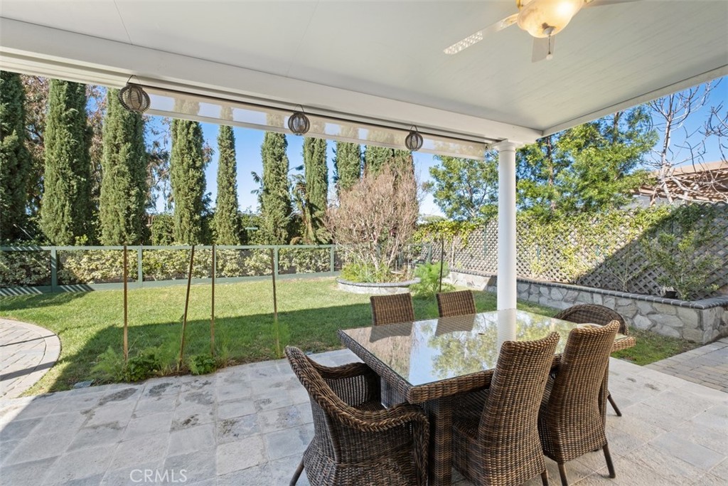 20891 Porter Ranch Road Rancho Santa Margarita, CA 92679 - Photo 30 of 40 a view of a porch with a table chairs and a yard