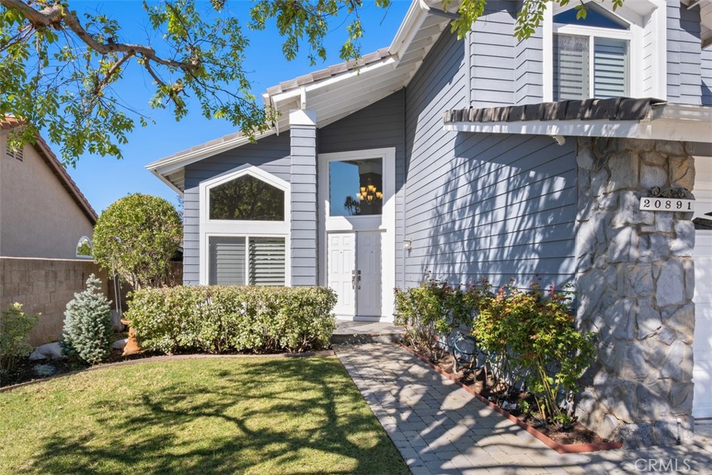 20891 Porter Ranch Road Rancho Santa Margarita, CA 92679 - Photo 3 of 40 a front view of a house with a yard