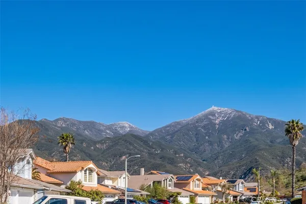 a view of a house with a tree in the background