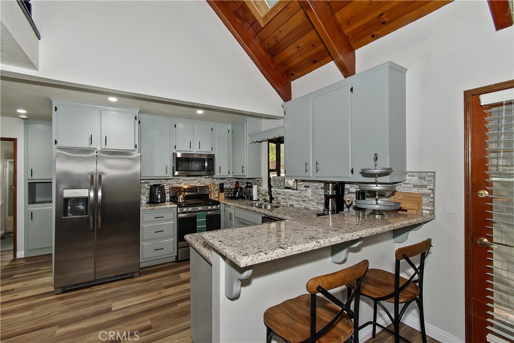 198 Zermatt Drive Crestline, CA 92325 - Photo 14 of 54 a kitchen with stainless steel appliances granite countertop a stove refrigerator sink and microwave