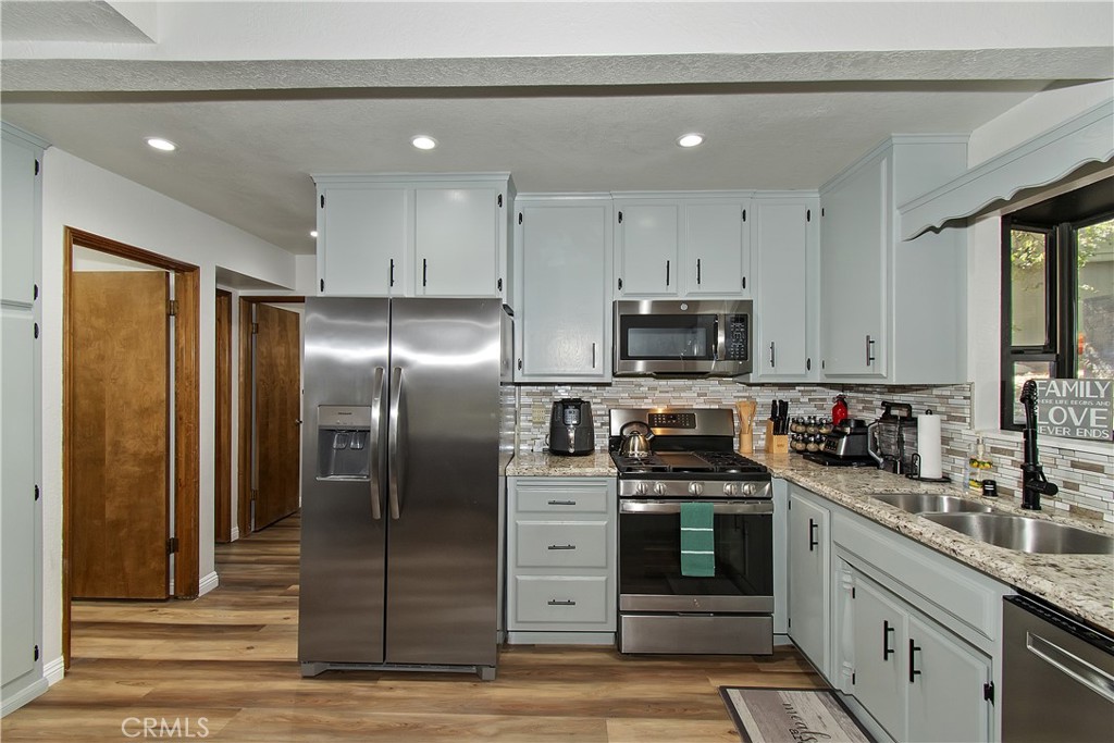 198 Zermatt Drive Crestline, CA 92325 - Photo 15 of 54 a kitchen with stainless steel appliances kitchen island granite countertop a refrigerator and a sink