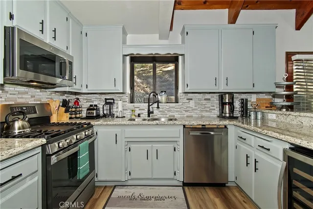 a kitchen with a sink stove and cabinets
