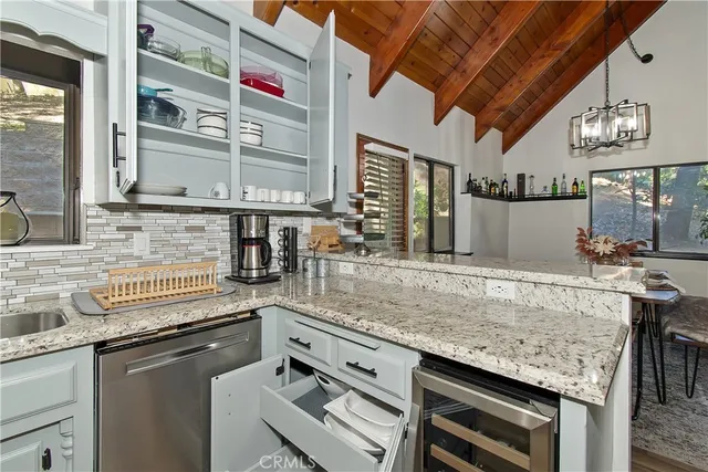 a kitchen with stainless steel appliances granite countertop a stove and a sink