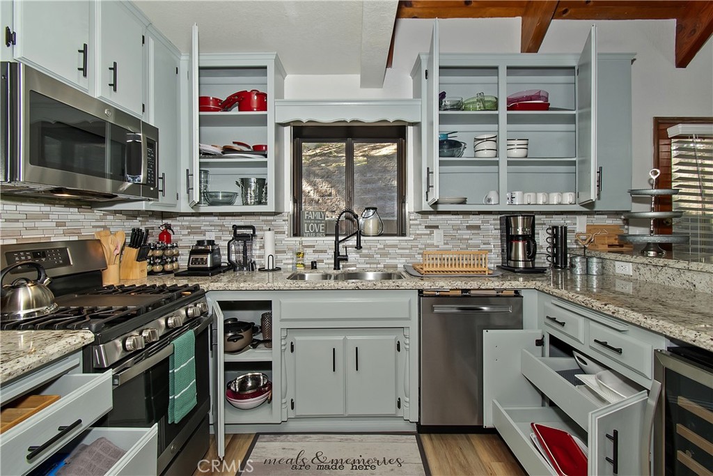 198 Zermatt Drive Crestline, CA 92325 - Photo 21 of 54 a kitchen with stainless steel appliances granite countertop a stove and a sink