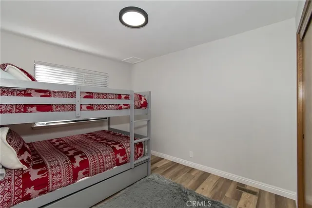 a view of a room that has a bed and a window in it