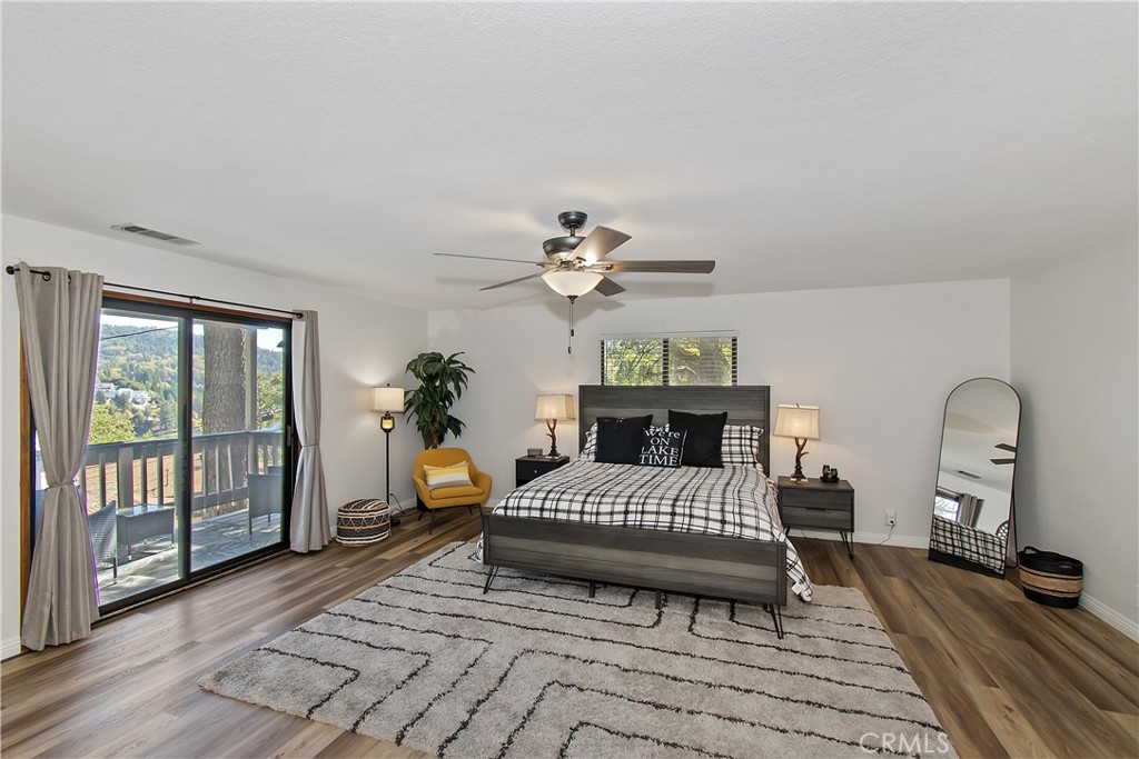 198 Zermatt Drive Crestline, CA 92325 - Photo 29 of 54 a bedroom with a bed and wooden floor