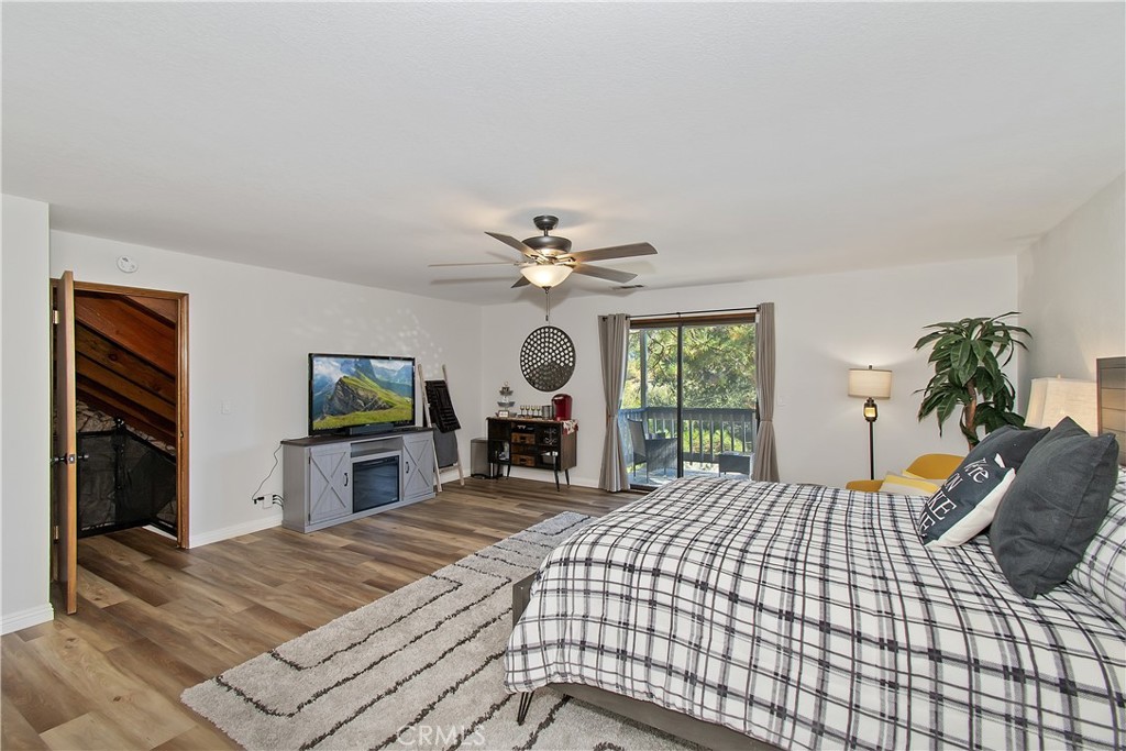 198 Zermatt Drive Crestline, CA 92325 - Photo 30 of 54 a bedroom with a bed and a flat tv screen on dresser